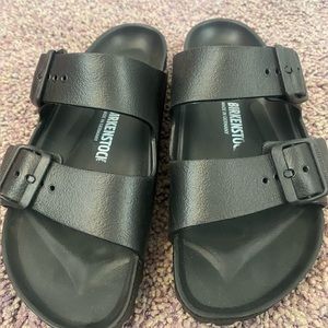 Black rubber Birkenstock sandals.